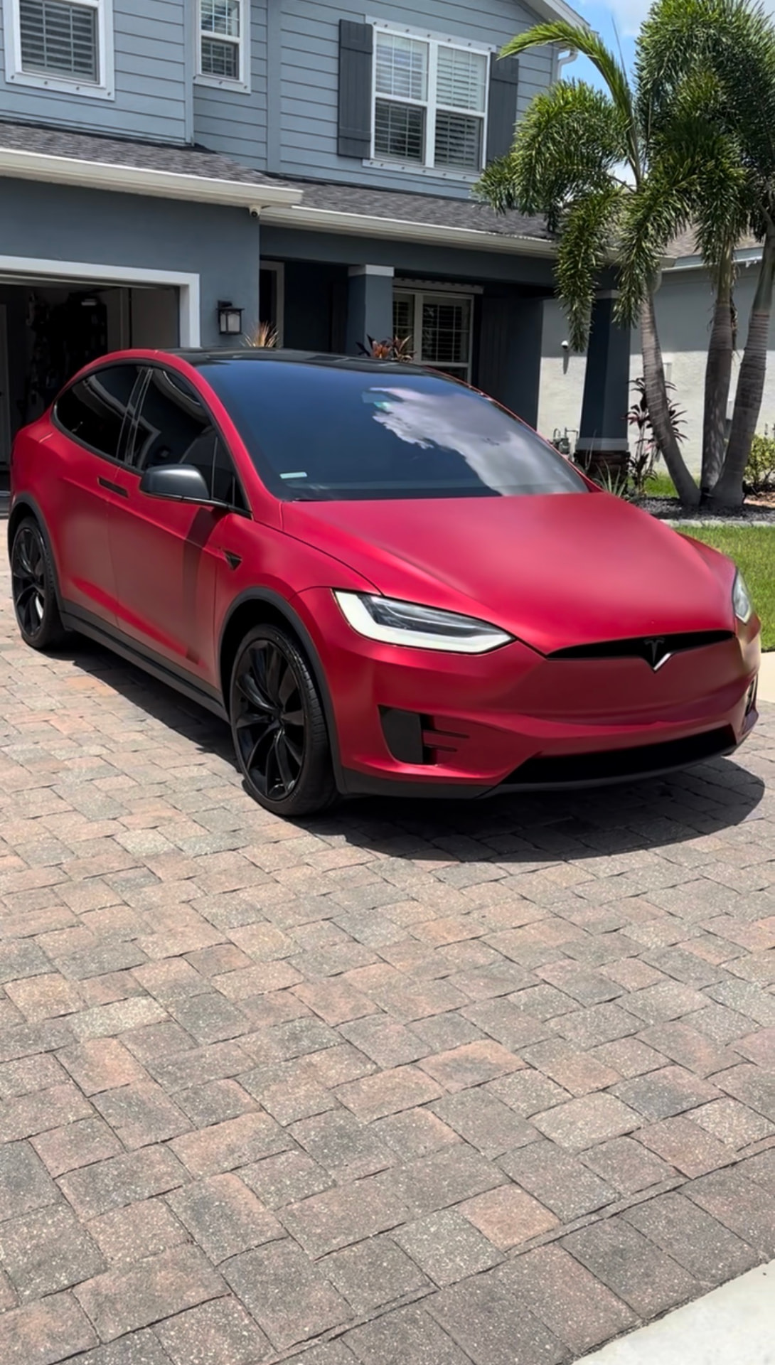Satin red Tesla Model X after a clay bar and wax service